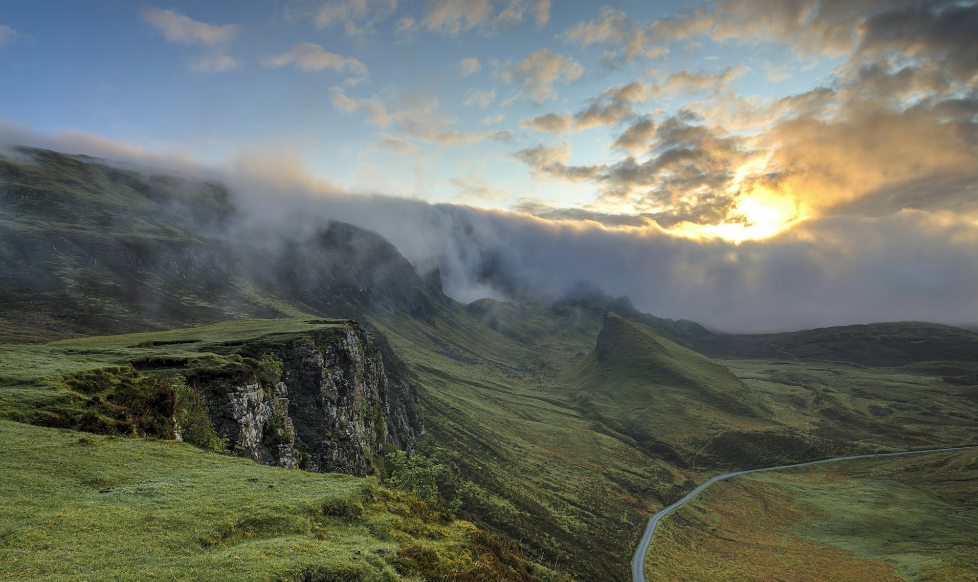 Mist rolling off green fells at first light